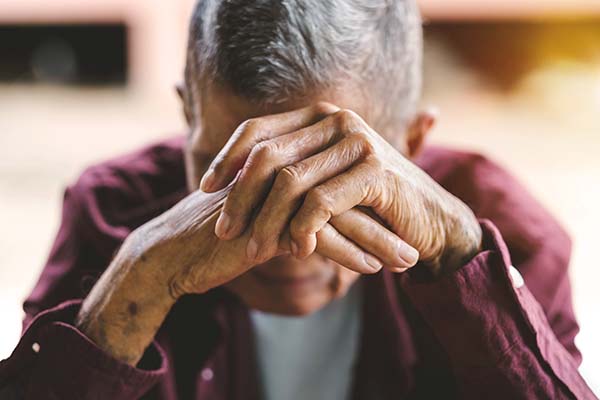 An elderly man suffering for elder abuse at home