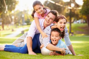 A family playing in the park after incorporating their values in their family estate planning